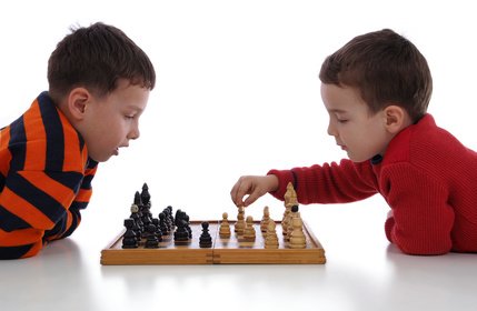 Two little boys playing chess